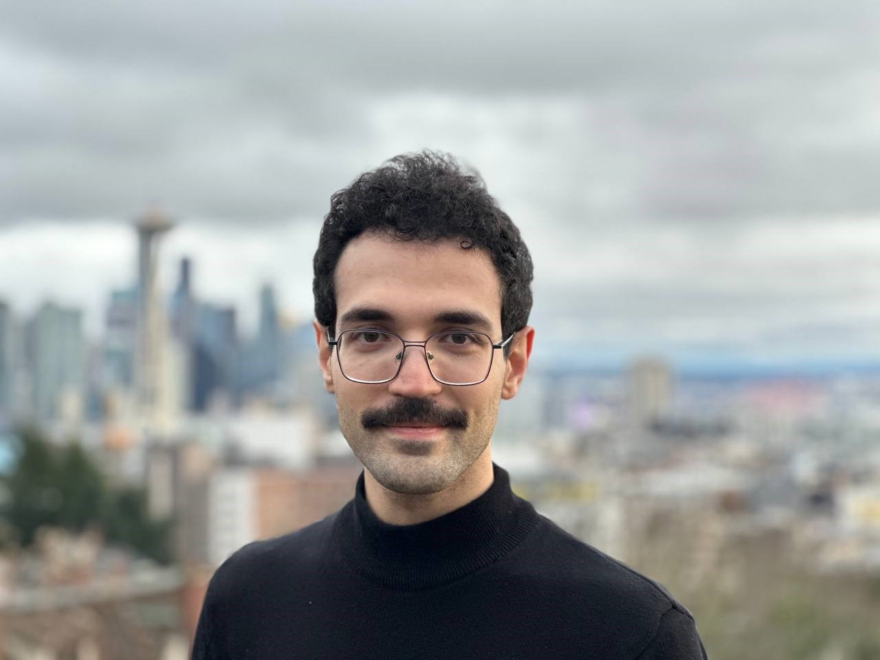 A person with a mustache and glasses

AI-generated content may be incorrect.