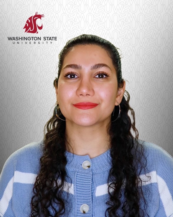 A person with long curly hair wearing a blue sweater

AI-generated content may be incorrect.