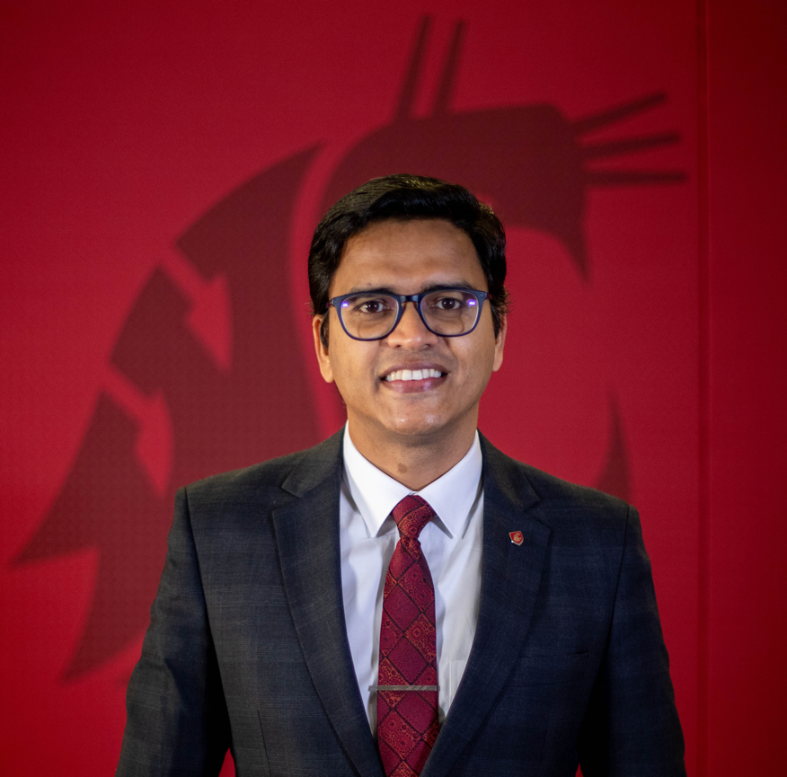 A person in a suit and tie

AI-generated content may be incorrect.