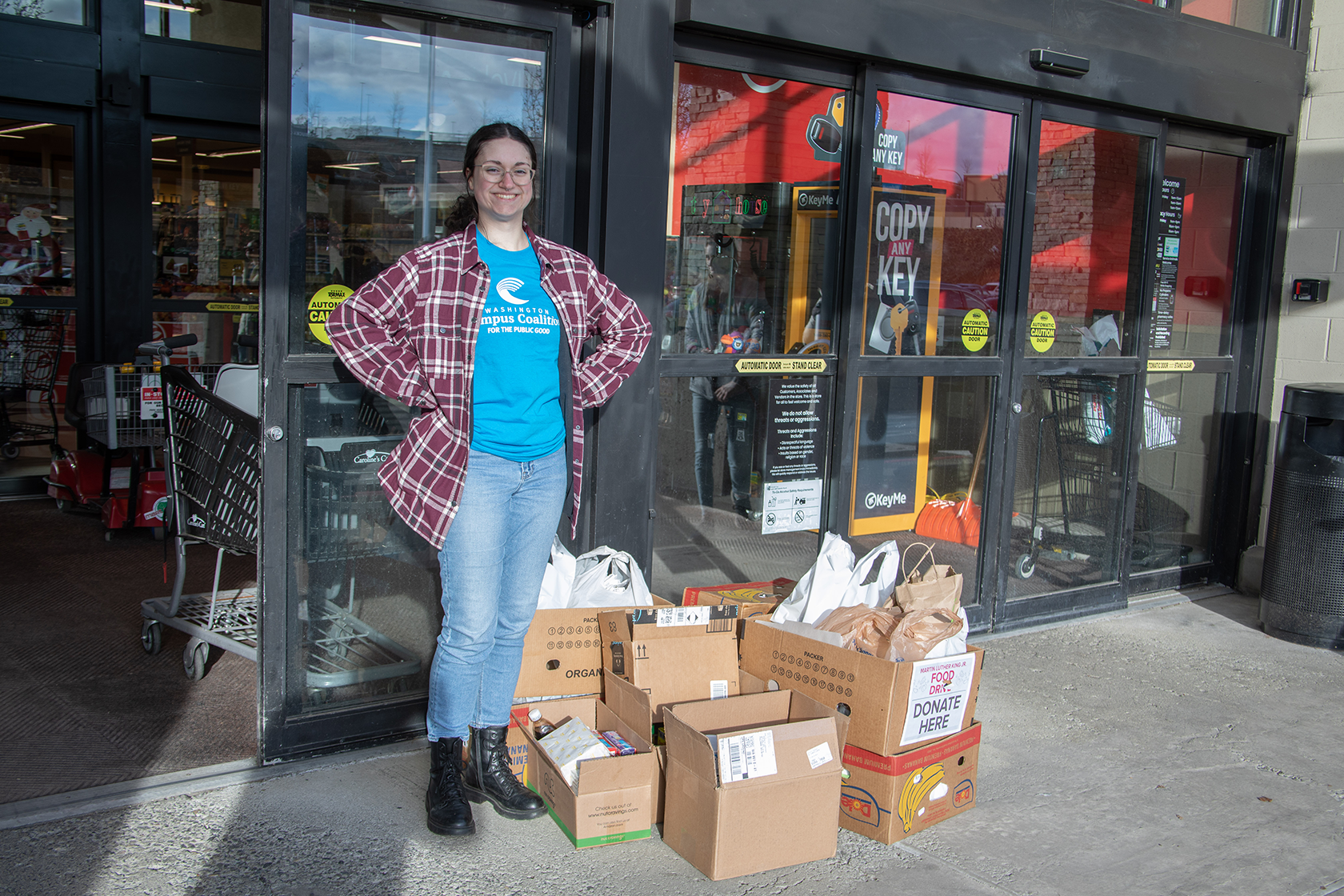 student stands by food resources