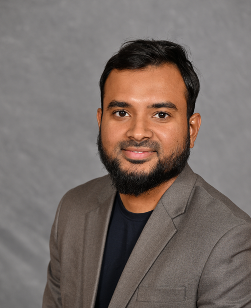 A person with a beard wearing a suit

AI-generated content may be incorrect.