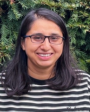 A person smiling in front of a tree

AI-generated content may be incorrect.
