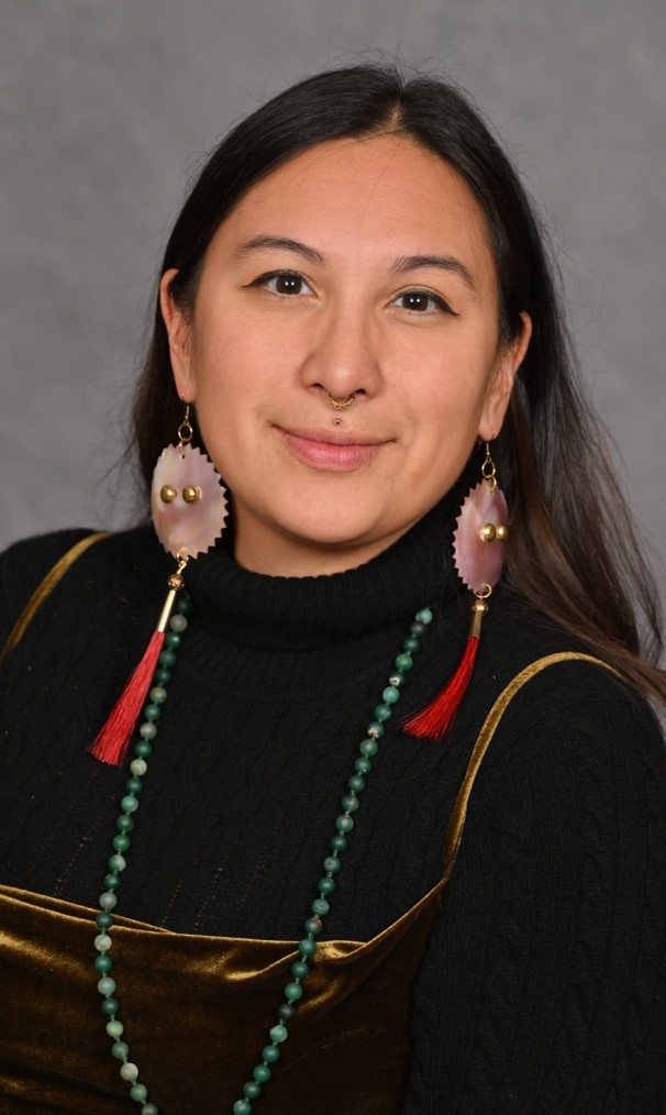 A person wearing a black turtleneck and earrings

AI-generated content may be incorrect.